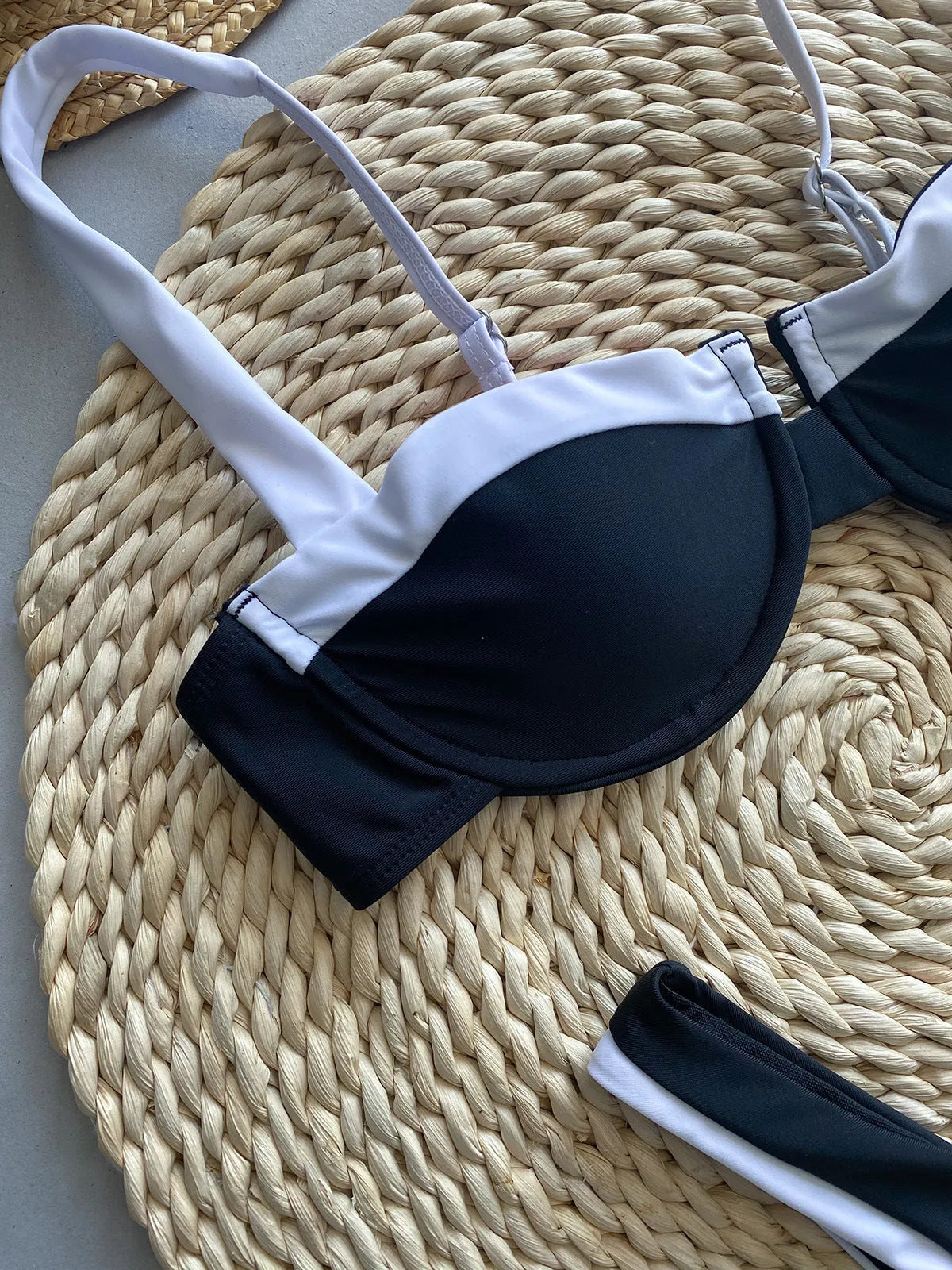 Black women's bikini briefs with stitching, showing front and back views