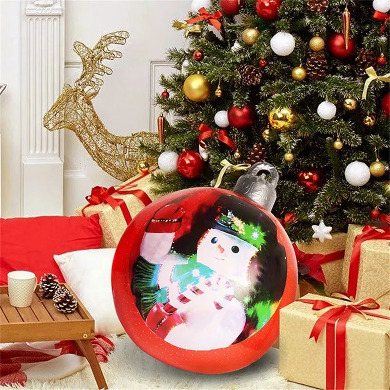 Large red and white striped inflatable Christmas ball ornament hanging on an outdoor tree