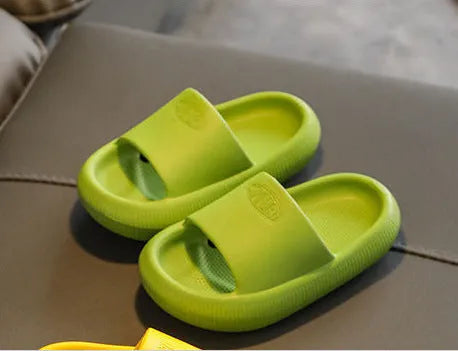 Colourful children's EVA slippers with a textured non-slip sole, shown in blue, green, orange, pink and yellow.