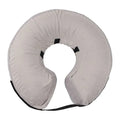 Blue soft inflatable dog recovery collar fastened around a dog's neck as an alternative to a plastic cone.