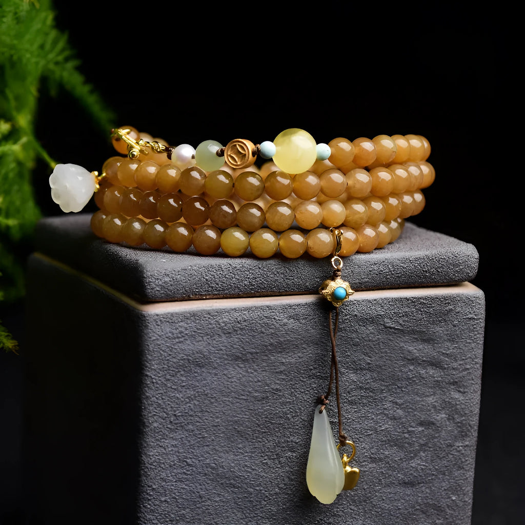 Close-up of a green jade bead bracelet with leaf sequins and a beeswax sheen.