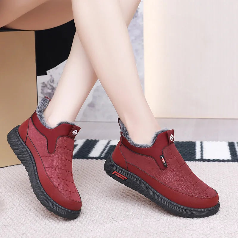 Women's black casual flat ankle boots with a round toe and non-slip rubber sole.