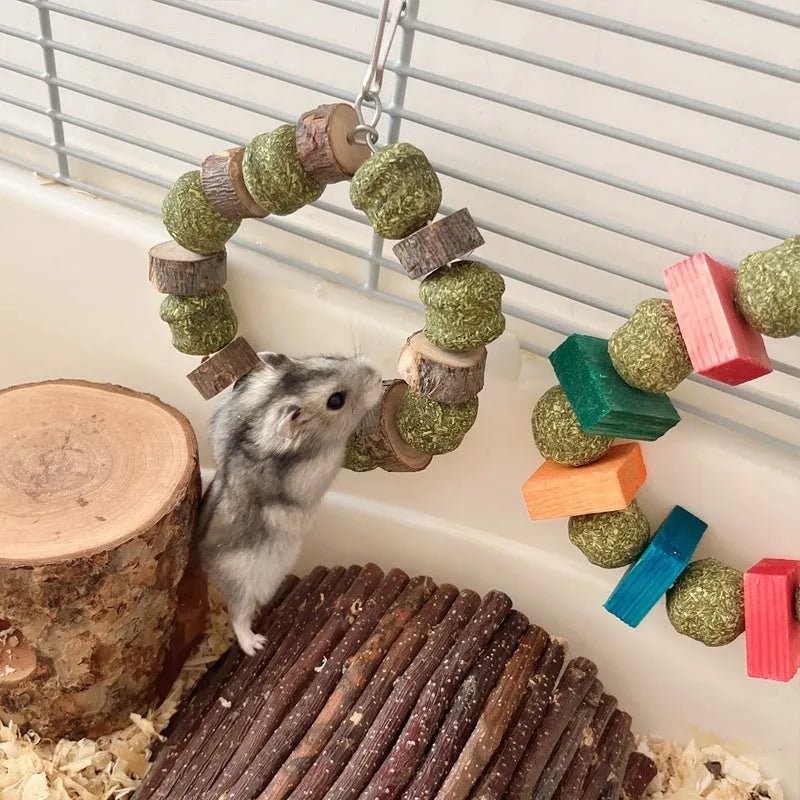 Hamster chew toy featuring applewood sticks and decorative straw balls with colourful sequins