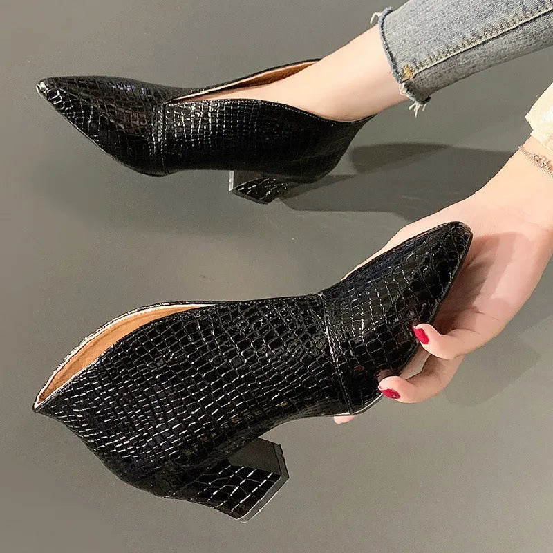 Women's black Martin boots with V-cut pointed toe, embossed artificial PU upper, and chunky heel