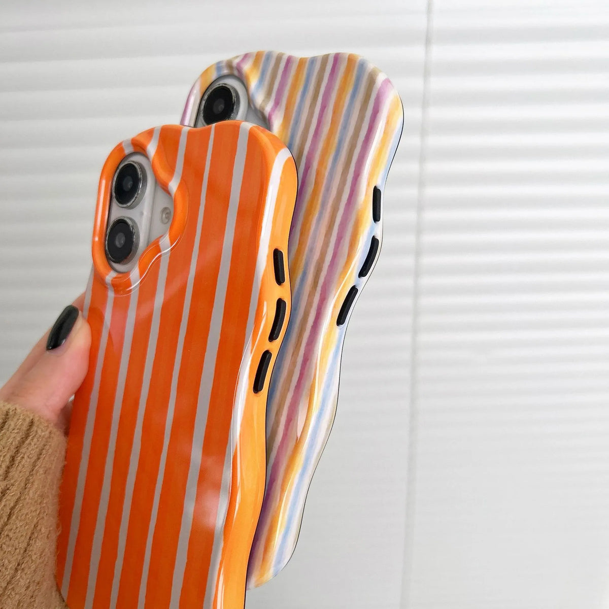 Colour-block striped film phone case showing orange and pink LQ5 wave stripe patterns on iPhone