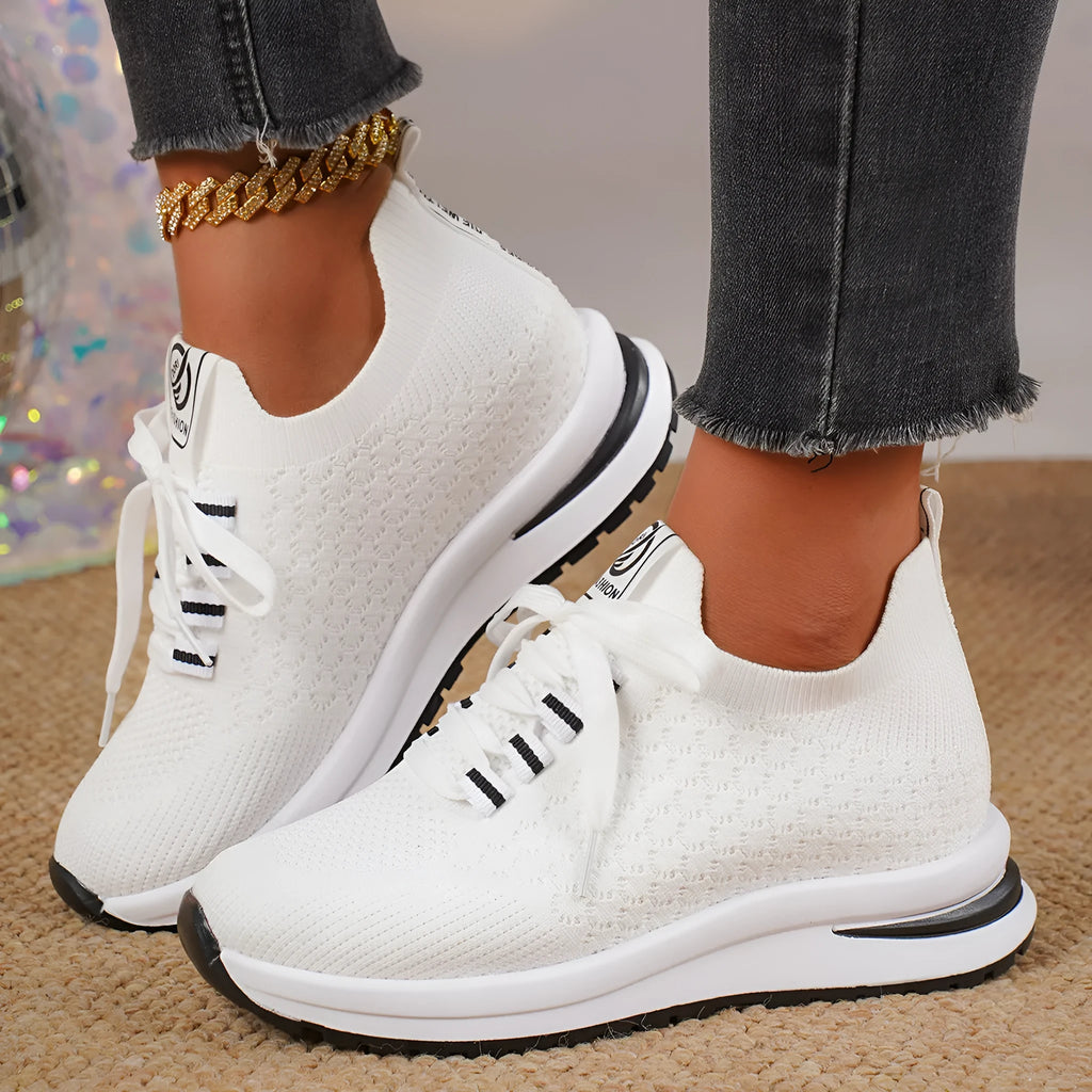 Women's black mesh lace-up flat pumps with round toe and rubber sole on white background