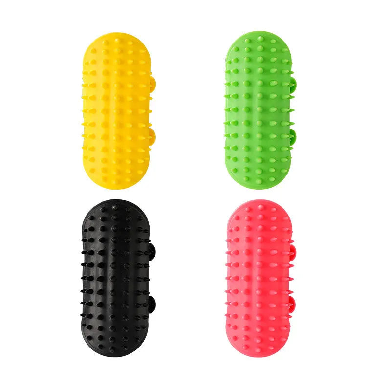 Black silicone cat grooming brush with comb teeth and an adjustable mounting strap.