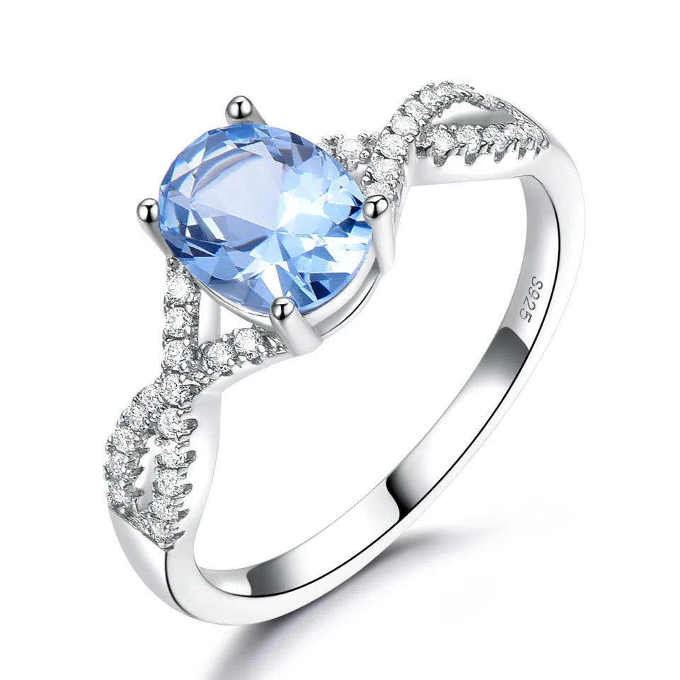 Sterling silver ring with oval nano morganite stone in round shape, available in multiple colours on white background