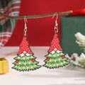 Wooden Christmas earrings with printed tree and snowman designs on geometric shapes