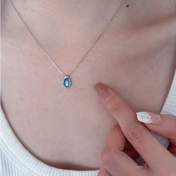 Women's navy blue geometric water drop pendant necklace on an adjustable copper chain.