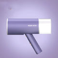 Foldable handheld clothes steamer in grey lotus root purple on a table.
