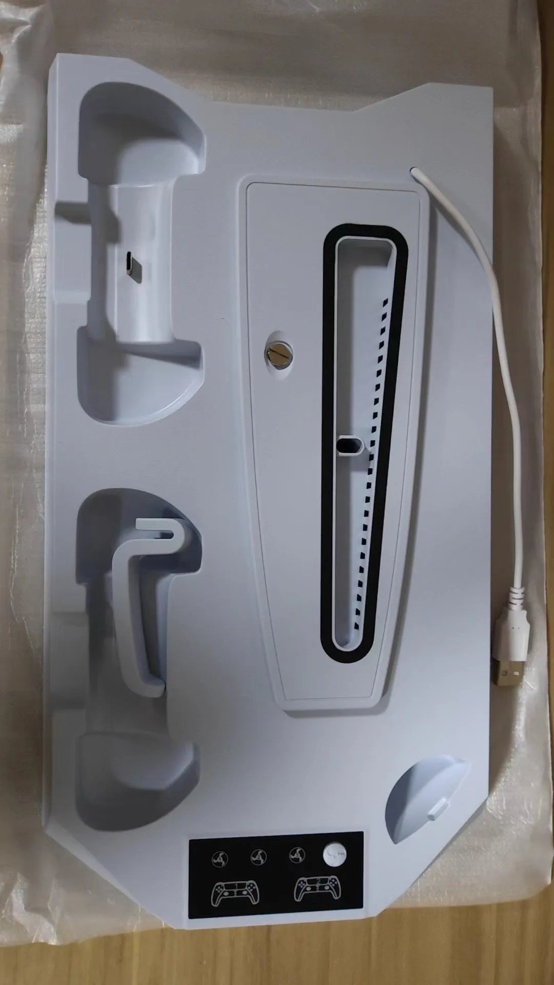 White PS5 charging base dock with two controllers charging and headset storage hook