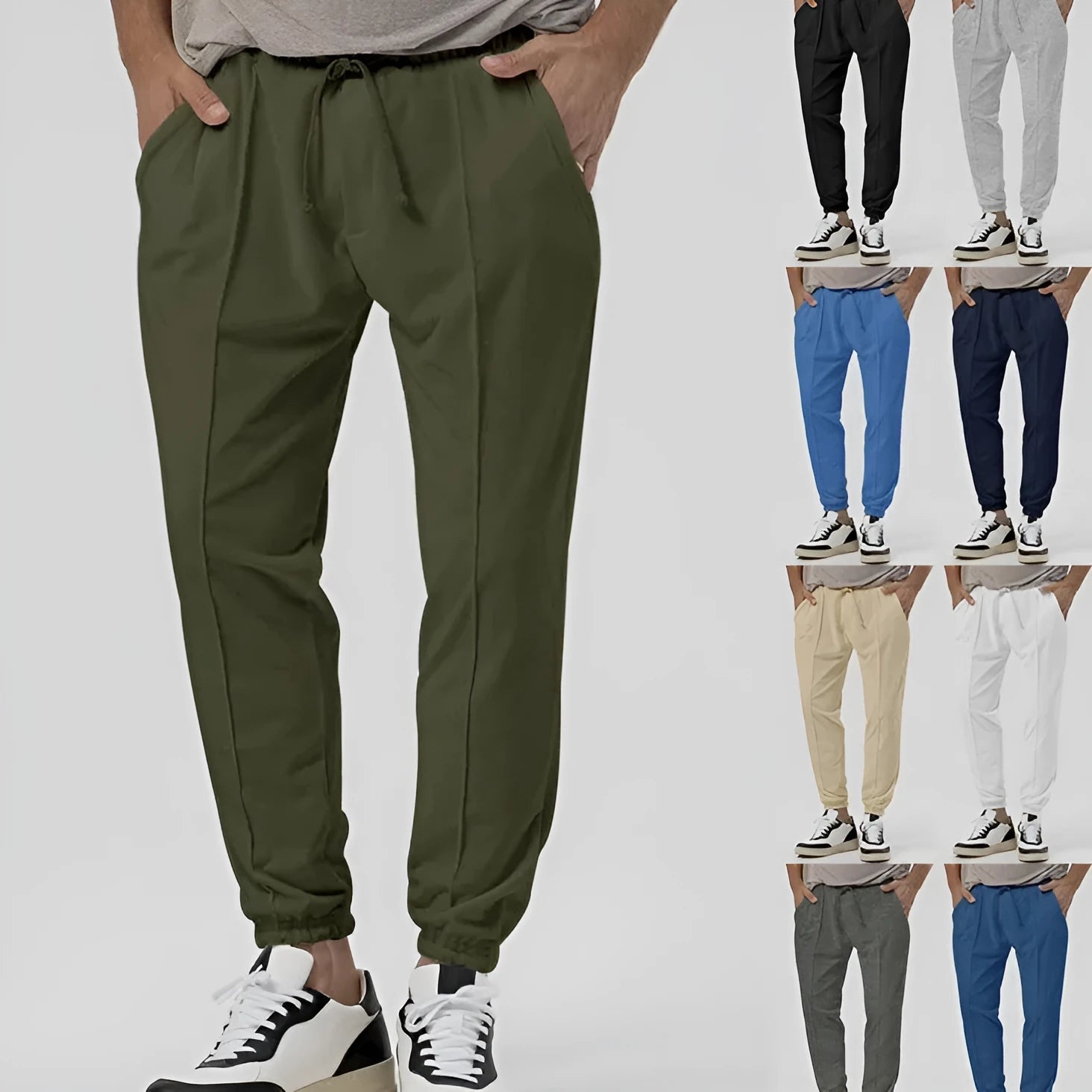 Man wearing grey loose tapered cotton blend track sweatpants with a straight leg.