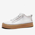 Men's black leather casual shoes with a round toe and white rubber sole on a plain background.