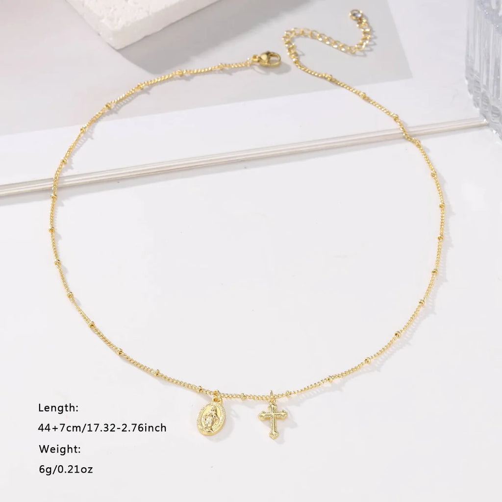 Geometric Virgin Mary cross pendant necklace in gold colour on a chain