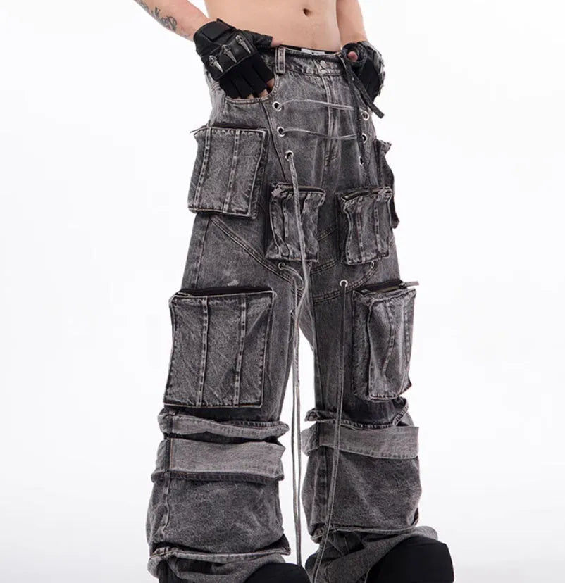 Grey distressed denim overalls with rope stitching on a hanger