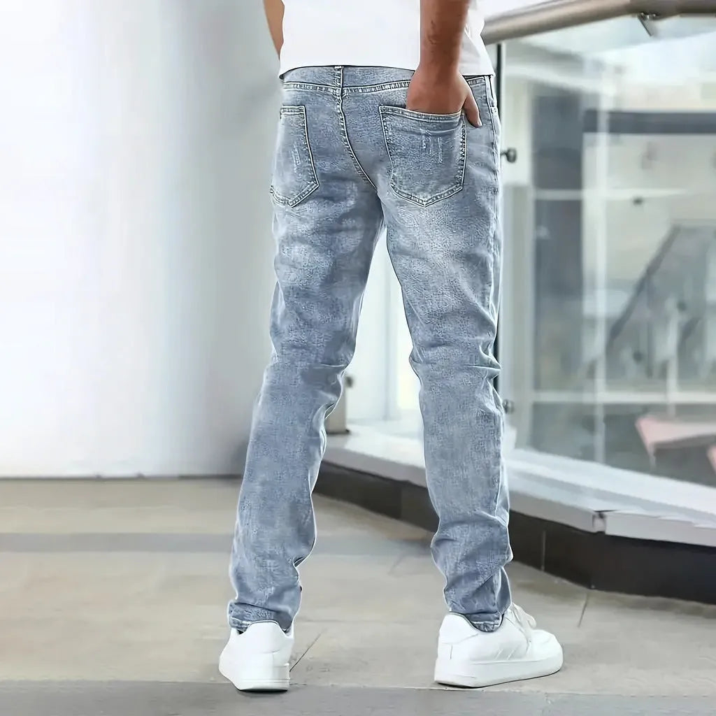 Men's straight leg jeans in stretch cotton denim showing high elasticity fabric and slim silhouette