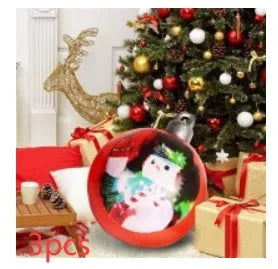 Large red and white striped inflatable Christmas ball ornament hanging on an outdoor tree