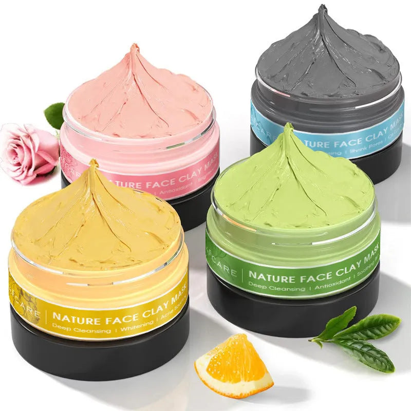 Set of four 80ml clay face mask jars: Dead Sea mud, green tea, turmeric, and rose formulas.