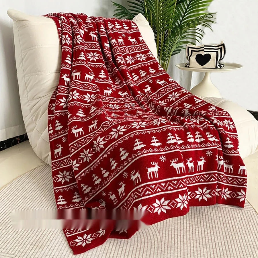 Christmas acrylic blanket with snowflake pattern in 110x130cm size on sofa