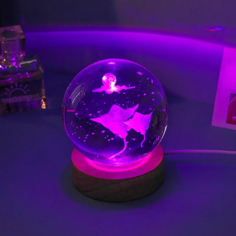 Colorful luminous crystal ball on light wooden base with data cable