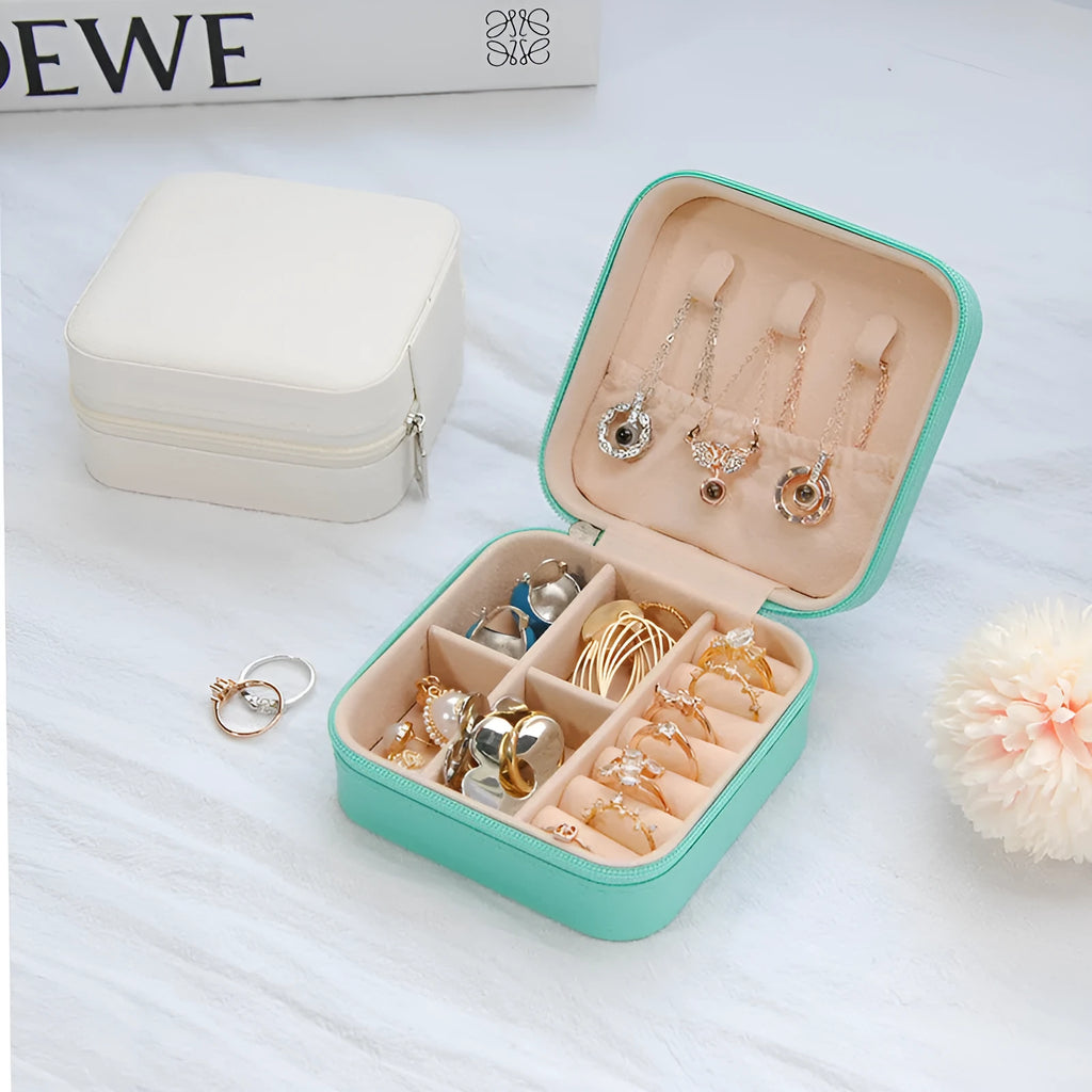 Small leather jewellery box in cross pattern, 10cm size, for earrings and rings, on a flat surface.
