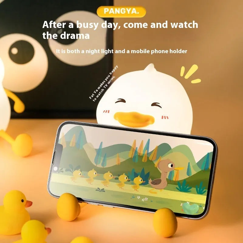 Chubby Night Light on a desk showing its compact size and silicone phone holder feature.