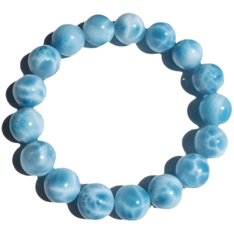 Blue Bodhi bracelet with natural sea-pattern crystal stones and pearl details in Maillard style.