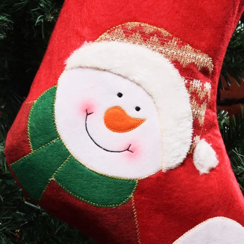Red Christmas stocking with elk and snowman pattern, made from non-woven fabric with hanging loop.