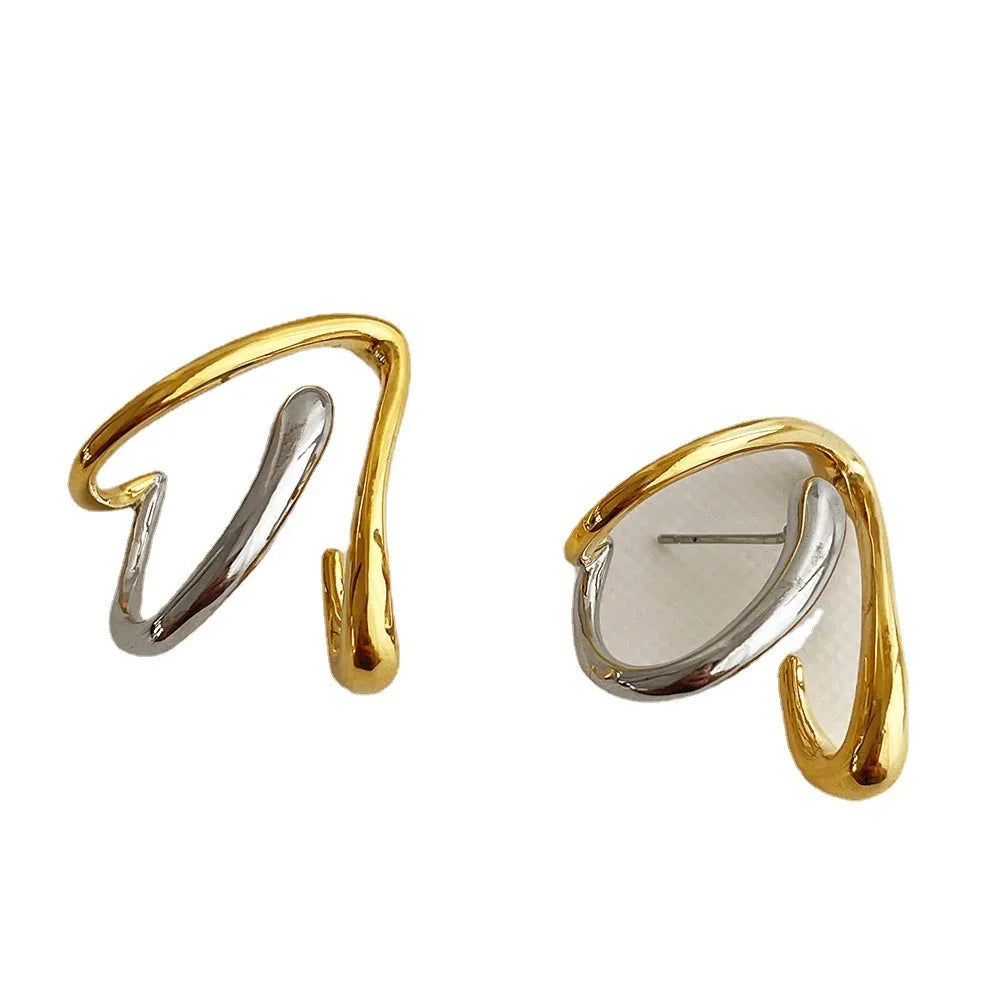 Gold and silver irregular triangle alloy stud earrings with sterling silver needle on neutral background