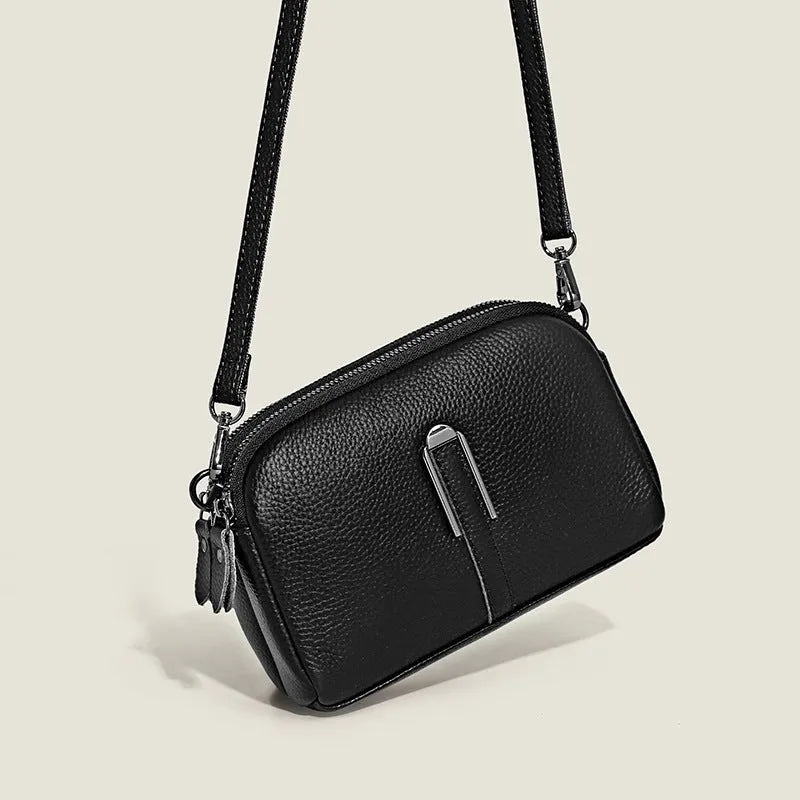 Minimalist crossbody bag in top-grain leather, horizontal square shape, available in five colours including khaki and black