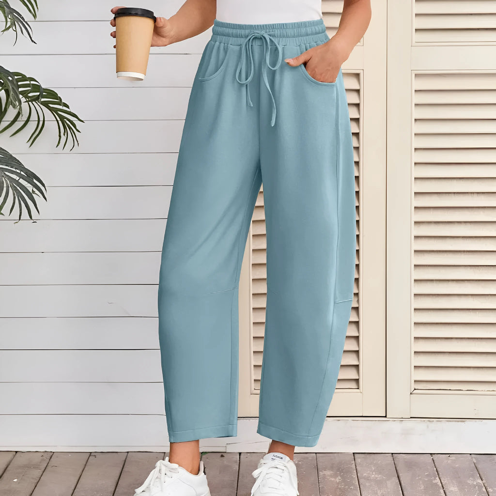 Loose cropped sweatpants with drawstring waist and side pockets in street fashion styling