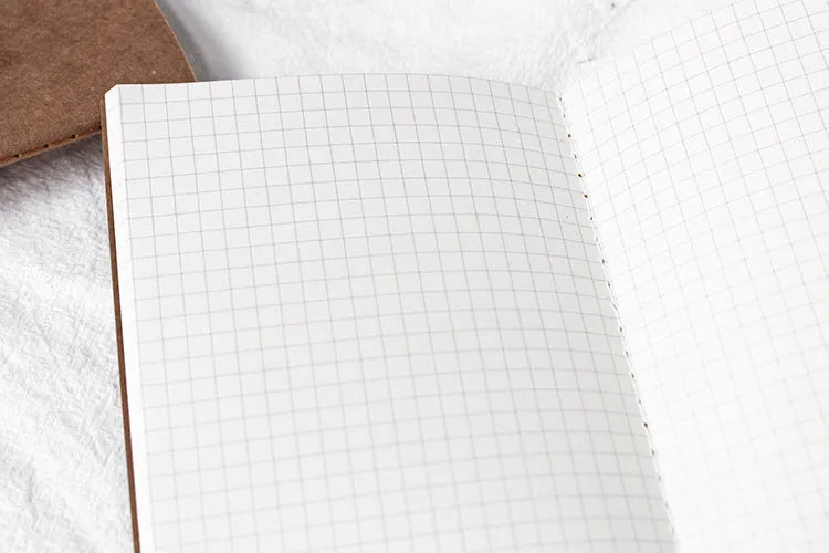 Cowhide diary refill inner core showing saddle stitch binding and 100g ivory white paper