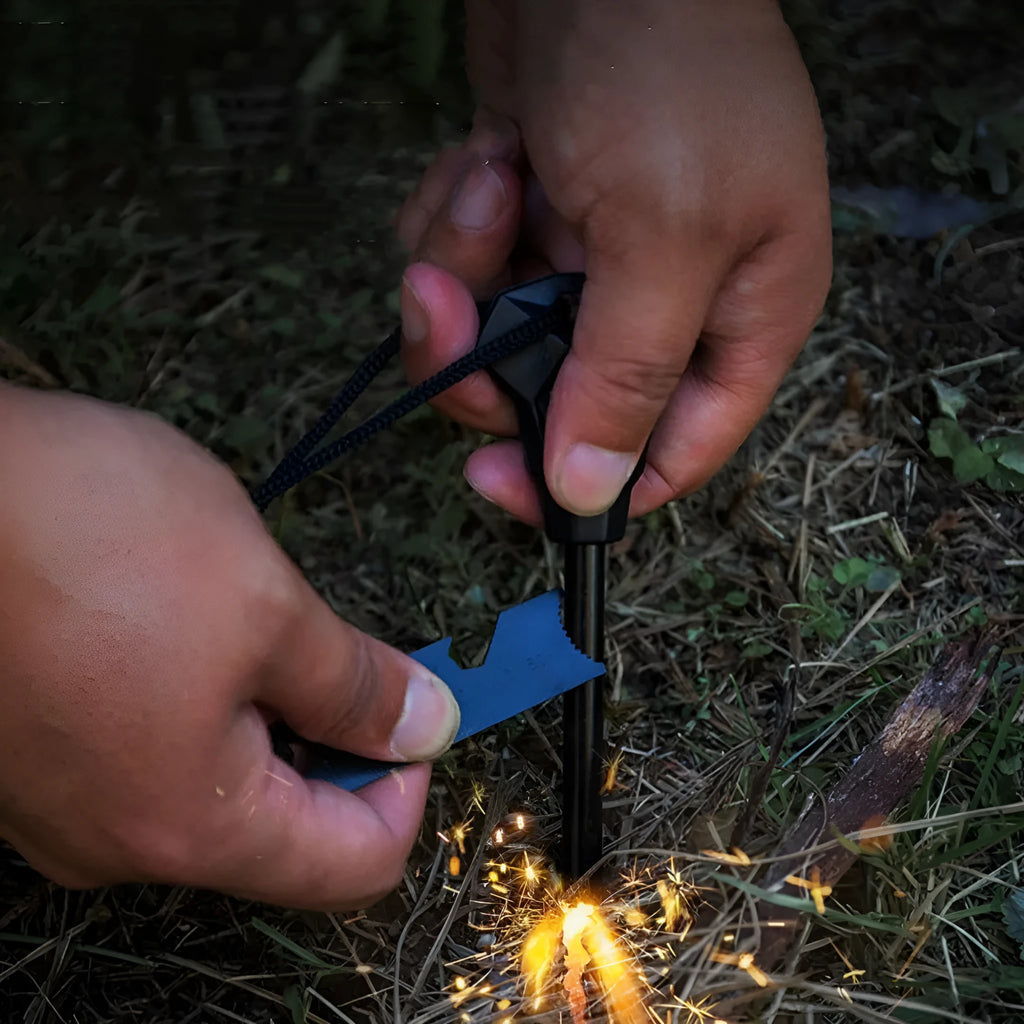 Black outdoor survival flint tool with magnesium rod, stainless steel scraper, whistle, and measurement scale.
