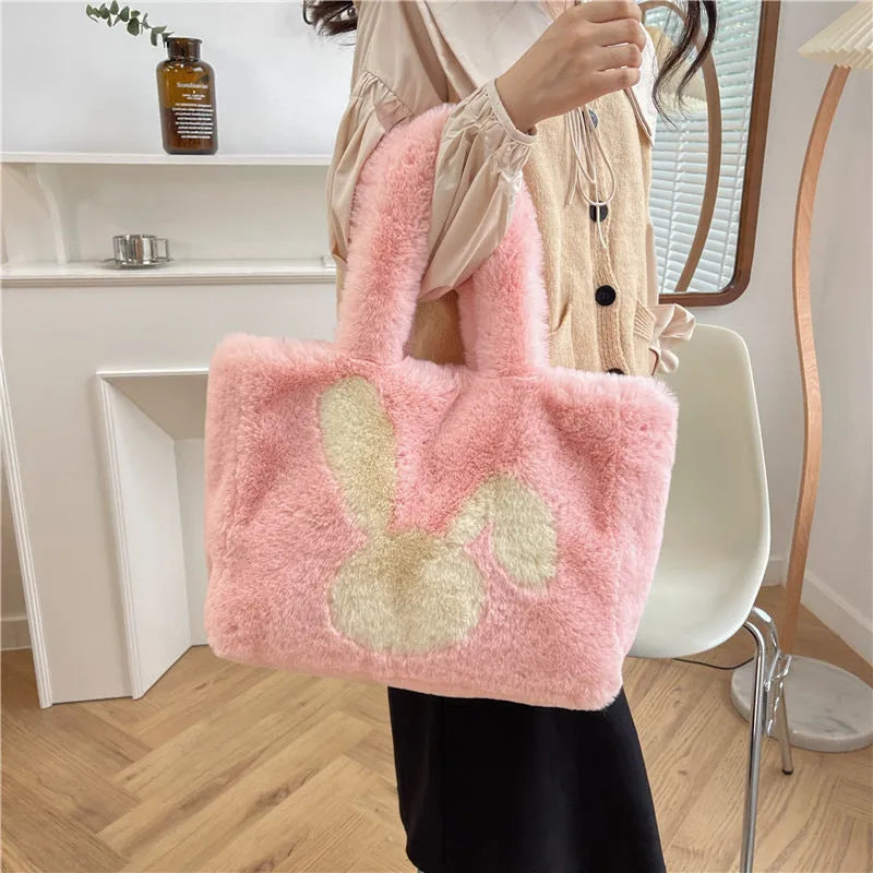 Soft beige plush tote bag with cartoon rabbit ears on the front, shown as a large capacity shoulder bag.