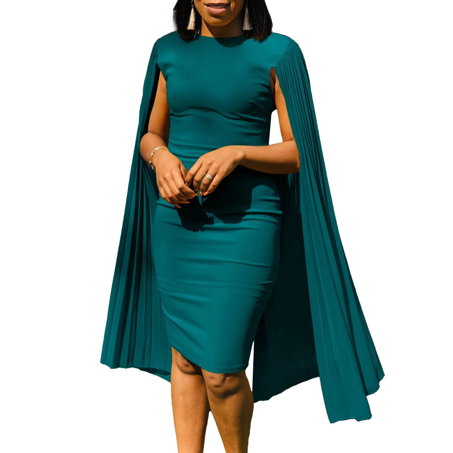 A woman wearing a green, round neck, long sleeve pleated shawl evening gown with a high waist.