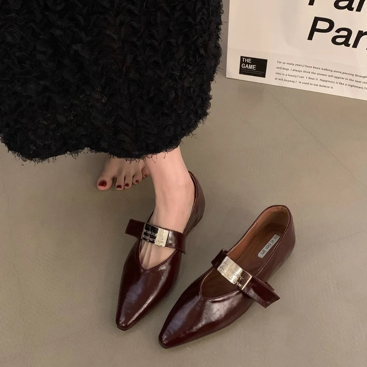 Women's silver pointed toe Mary Jane shoes with a buckle fastening, shown in black and wine red.