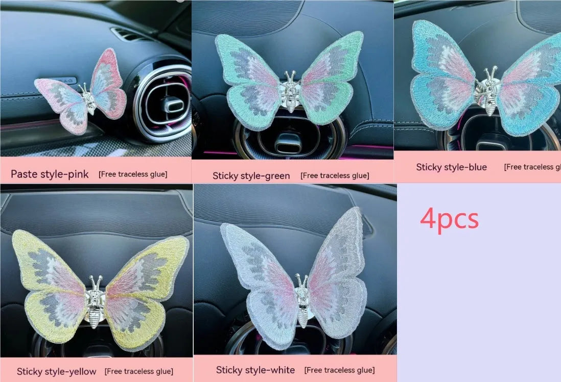 Fabric embroidered butterfly car air vent decoration in multiple colour options on a dashboard.