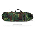 Lightweight waterproof nylon skate backpack in camouflage colour, shown with skateboard and fishing rod.