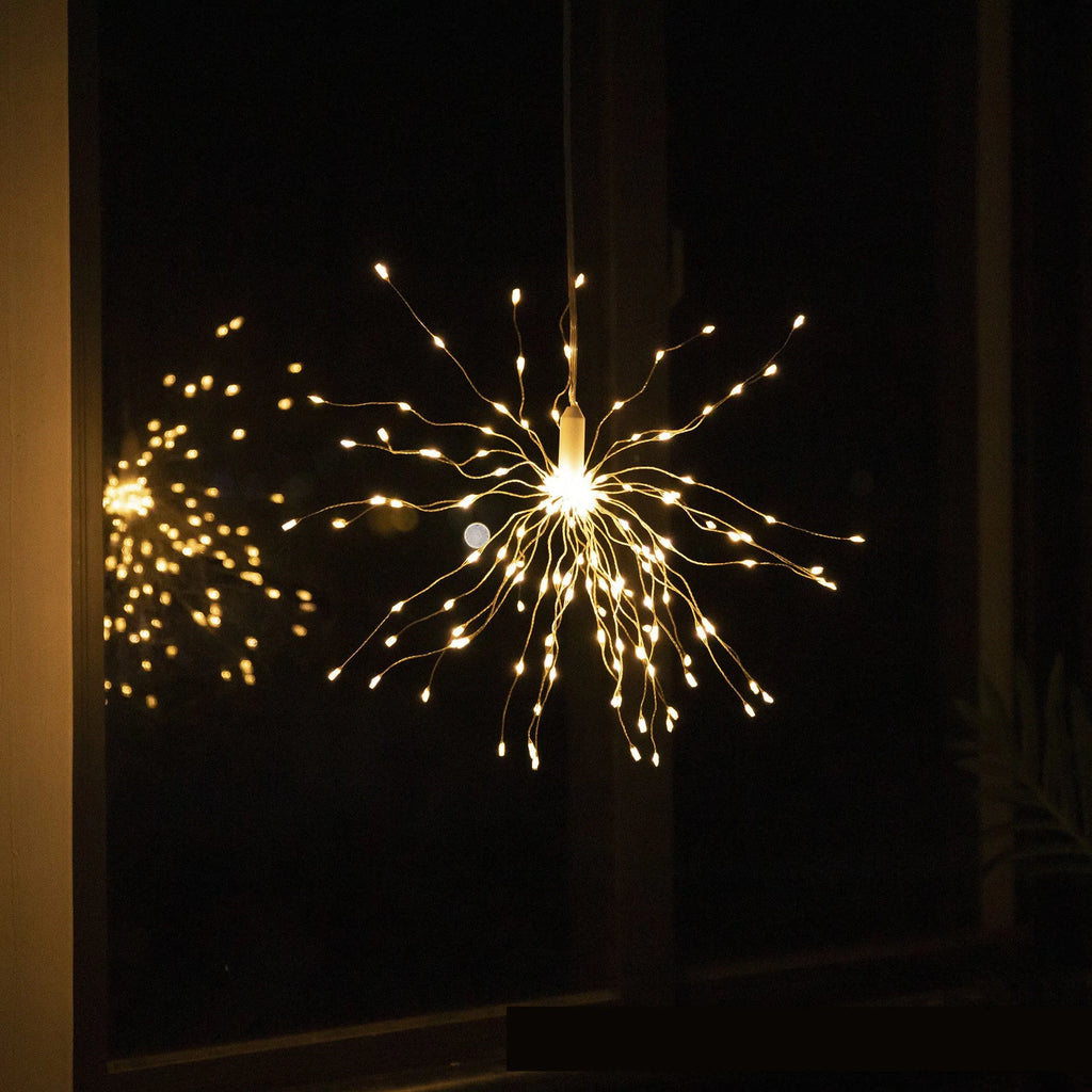Outdoor waterproof dandelion string lights with warm colour glow on a garden fence