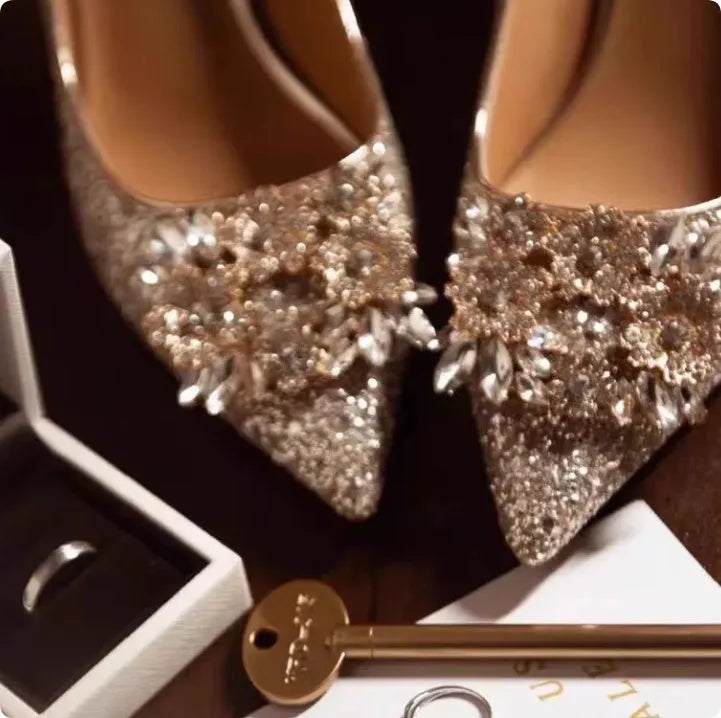 Champagne coloured women's wedding shoes with rhinestone flower pattern, pointed toe, and a fine heel.