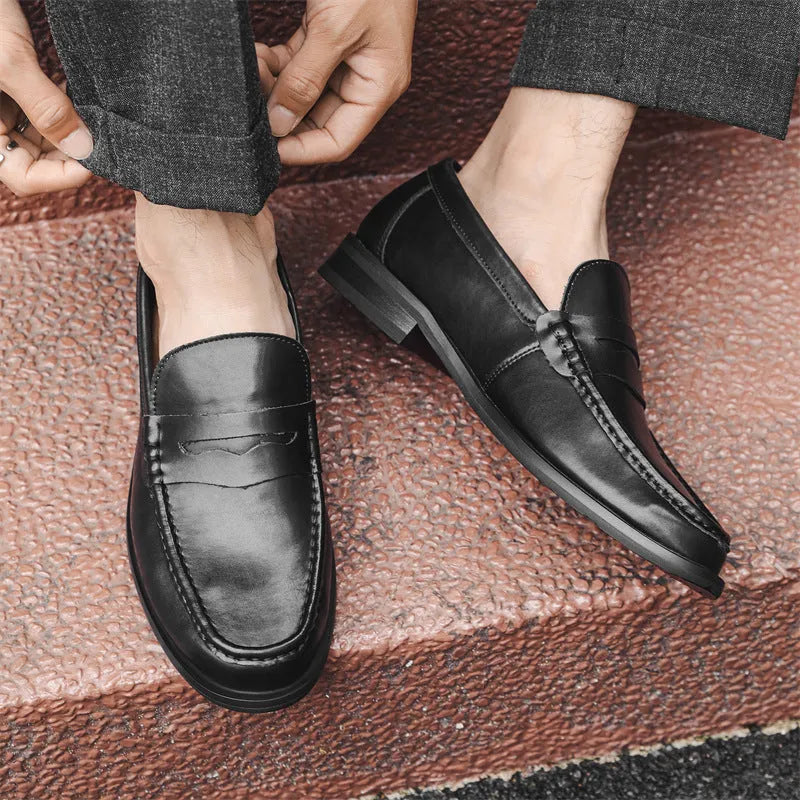 Men's black casual slip-on leather shoes with soft bottom and sewing line detail on a clean background
