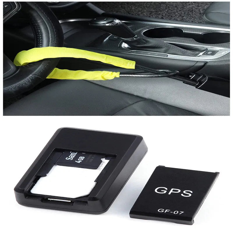 Small black plastic magnetic GPS tracker device next to a USB charging cable.