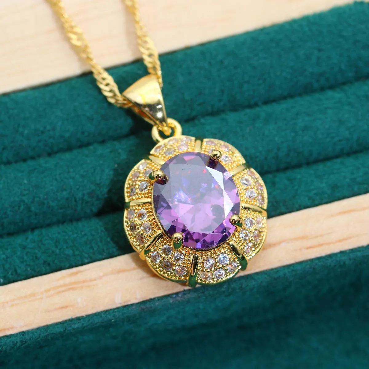 18k gold plated jewellery set showing ring, earrings, bracelet, and necklace with coloured cubic zirconia stones