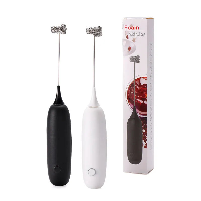 Black and white electric hand-held milk frother and blender for coffee beverages