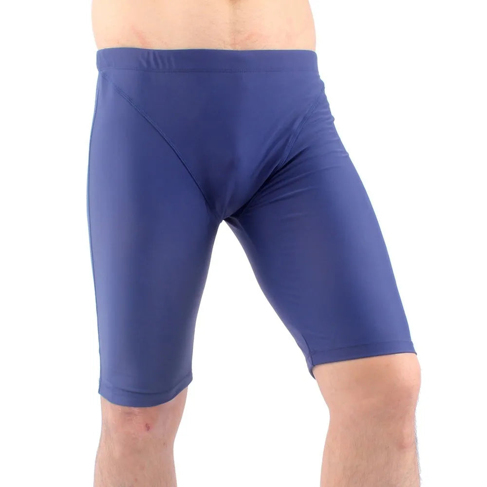 Green and navy blue men's loose-fit swimming trunks with a five-point design and polyester lining.