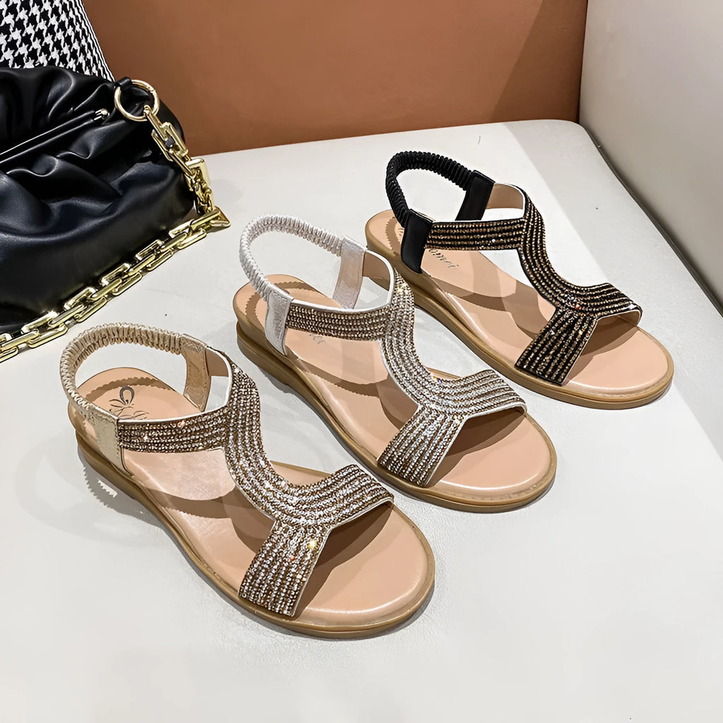 Gold women's patent leather beach sandals with rhinestone decoration on the straps.
