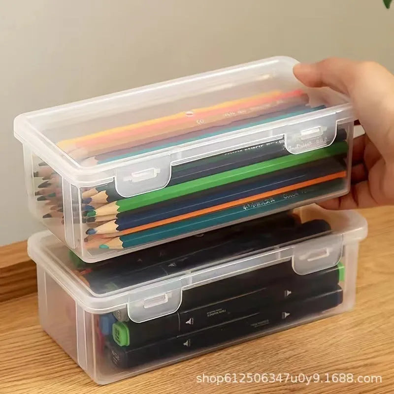 Large clear plastic stationery storage box filled with coloured pencils and crayons