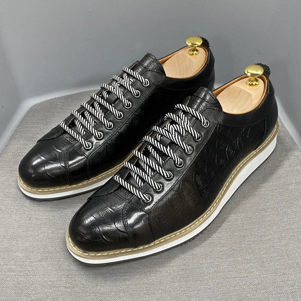 Handmade men's low-cut shoes with an embossed pattern and front-tie lacing.