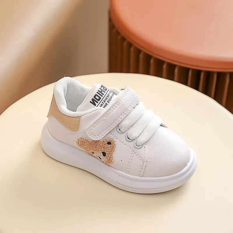 Children's black cartoon bear casual sports shoes with artificial leather upper and rubber sole.